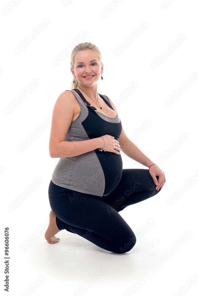 Pregnant woman doing sport exercises in yoga style Pregnant woman doing sport exercises in yoga style