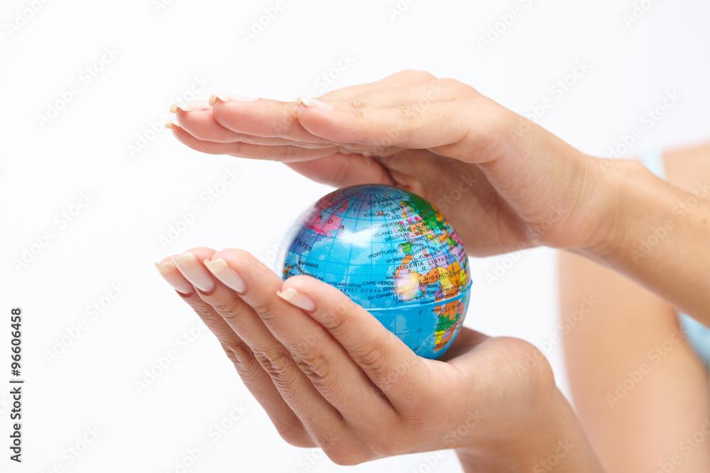woman's hand with globe woman's hand with globe