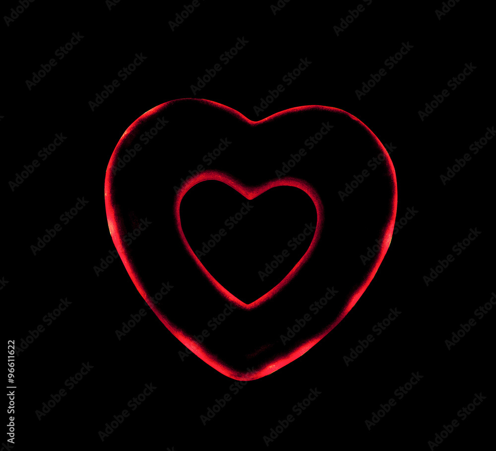 artificial red heart on a black background artificial red heart on a black background