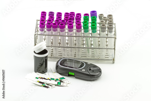 Medical Blood tube, test tube for laboratory empty on  rack and Many strip test of blood glucose meter, the blood sugar value is measured on a finger on white background photo