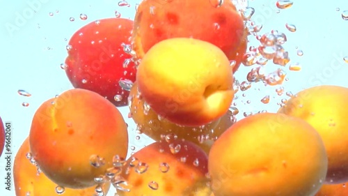 Apricot. Fresh and ripe organic apricots falling in water. Bio Fruits. Slow motion 240 fps. 