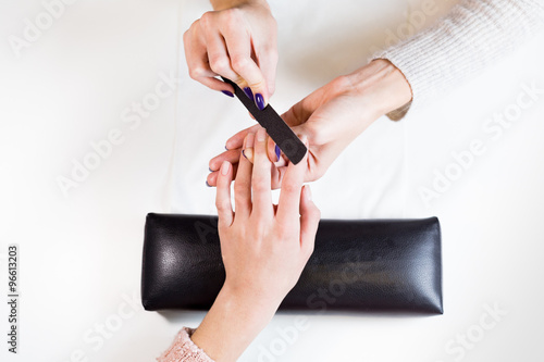 Image of hands polishing fingers on towel 