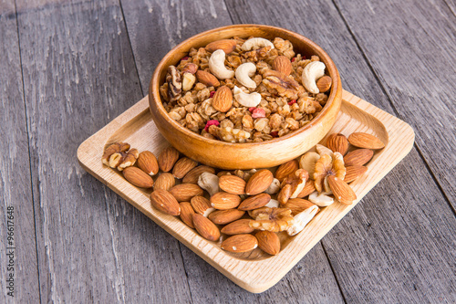 Bowl of breakfast muesli mixed with dried fruit and nuts in a wo