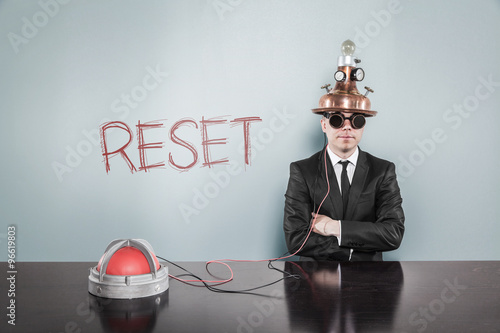 Reset concept with vintage businessman and calculator photo