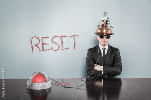 Photos Reset concept with vintage businessman and calculator