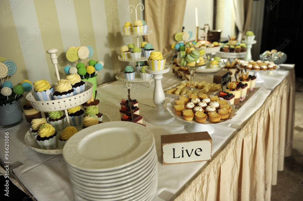 Sweets corner with LIVE inscription on the table
