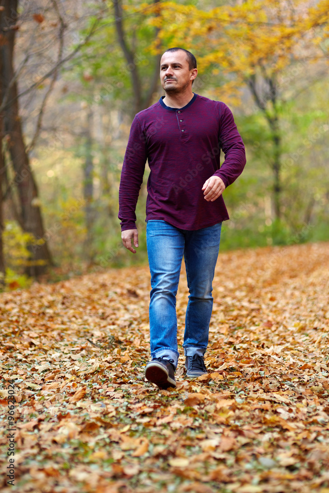 Caucasian man walking in the forest