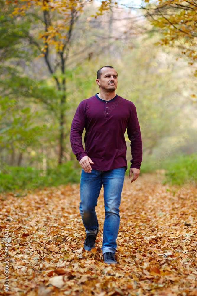 Caucasian man walking in the forest Caucasian man walking in the forest