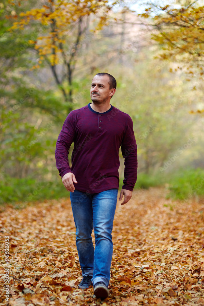 Caucasian man walking in the forest Caucasian man walking in the forest