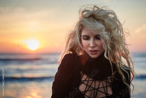 Beautiful woman on the beach at sunrise