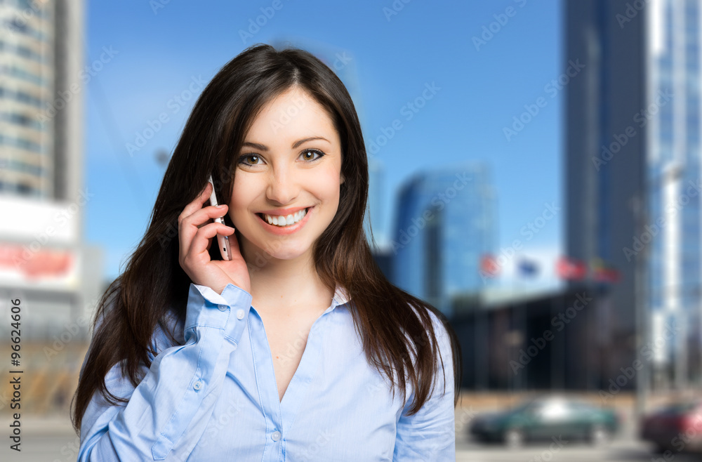 Smiling businesswoman talking on the phone Smiling businesswoman talking on the phone
