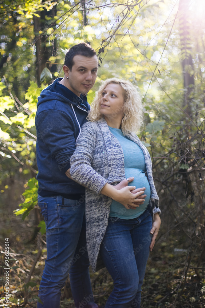 Young pregnant couple in the park