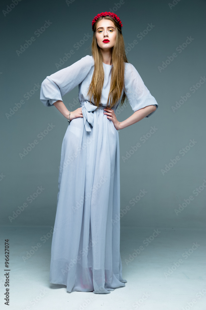 Beautifull female model long-haired woman wearing dress and red wreath with red lips Beautifull female model long-haired woman wearing dress and red wreath with red lips