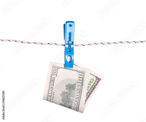 Dollar bills hanging on rope attached with clothes pins.