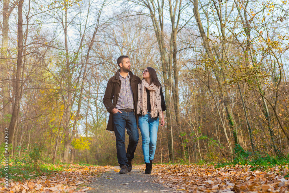 Young couple walking through the park Young couple walking through the park