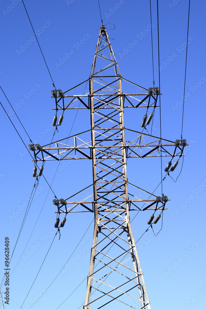 High-voltage power line on background of blue sky