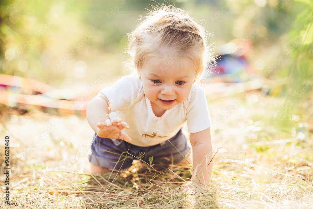 little girl crawling on the lawn