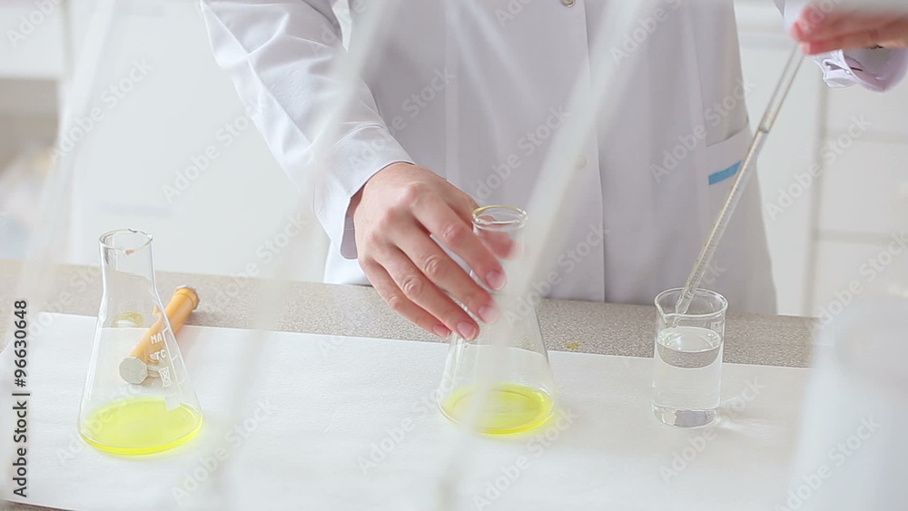 Researcher works with fluids in chemical laboratory Researcher works with fluids in chemical laboratory