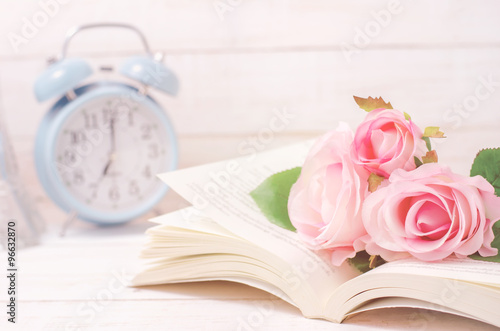 Pastel artificial rose and open book with vintage tone
