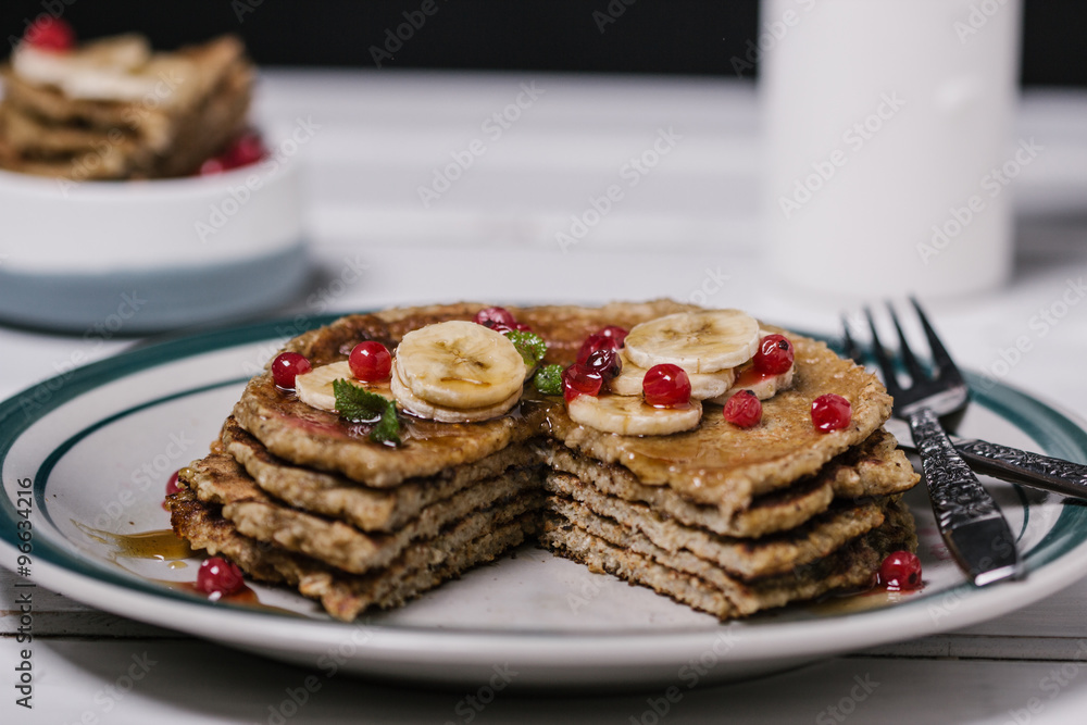 Stack of healthy low carbs oat pancakes over white wooden background Stack of healthy low carbs oat pancakes over white wooden background