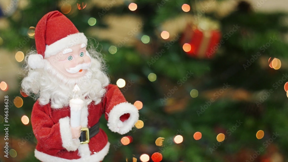 Toy Santa Claus moves at background bokeh lights Toy Santa Claus moves at background bokeh lights