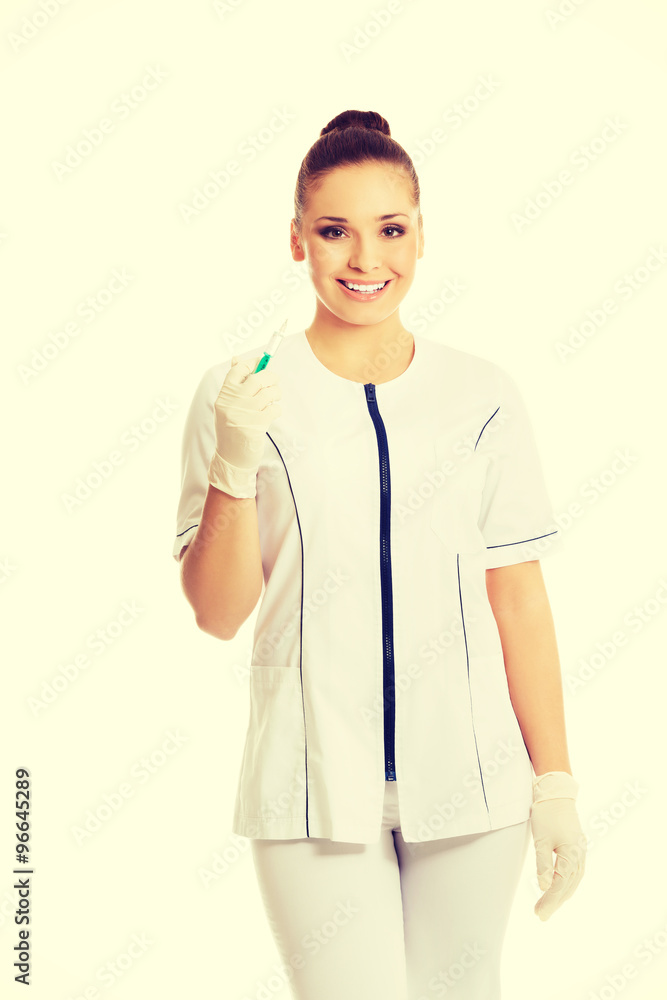 Female dentist holding a syringe Female dentist holding a syringe