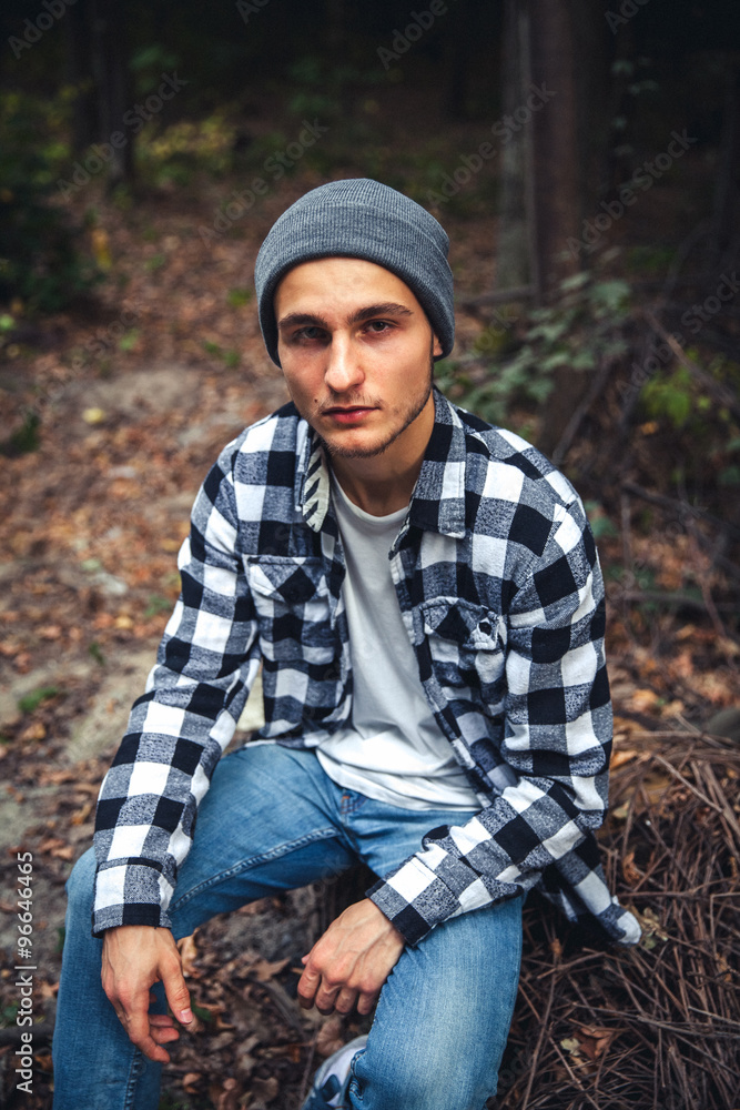 Portrait of young handsome man with backpack wanderer walk in the woods Portrait of young handsome man with backpack wanderer walk in the woods