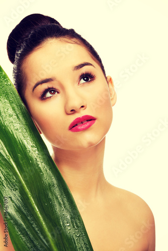Beautiful woman with green leaf.