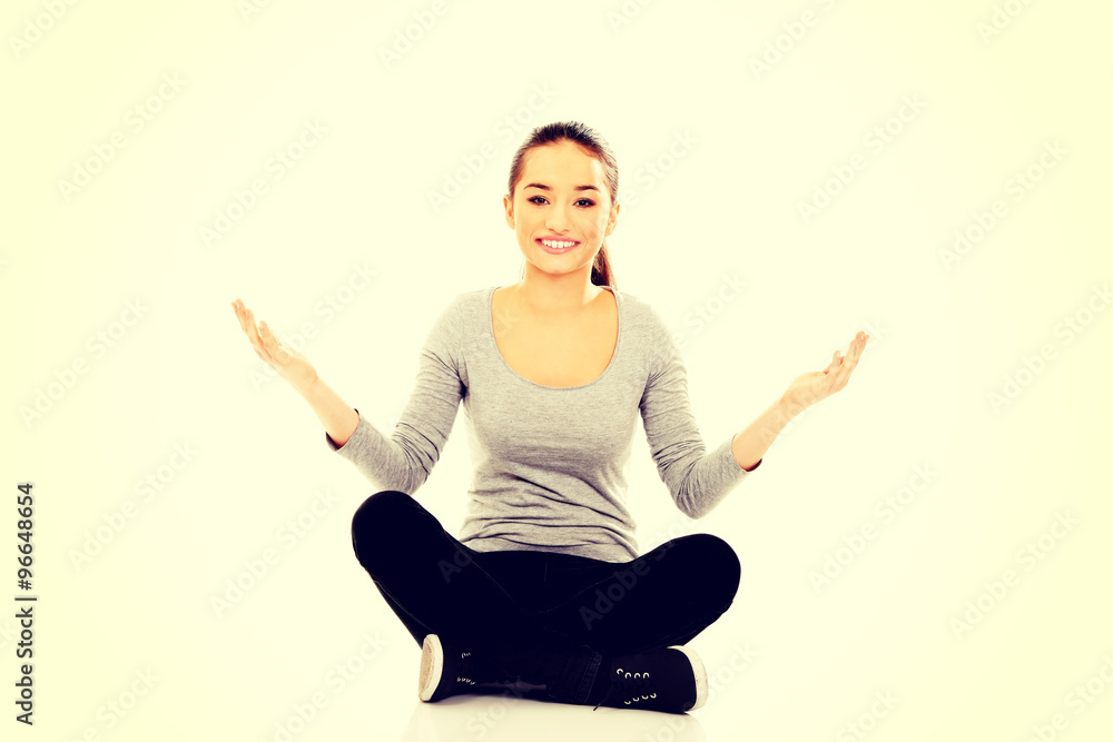 Woman sitting cross legged with open hands. Woman sitting cross legged with open hands.