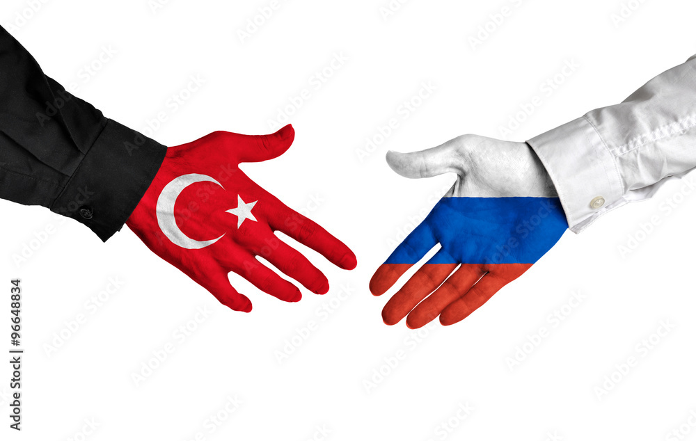 Turkey and Russia leaders shaking hands on a deal agreement Turkey and Russia leaders shaking hands on a deal agreement