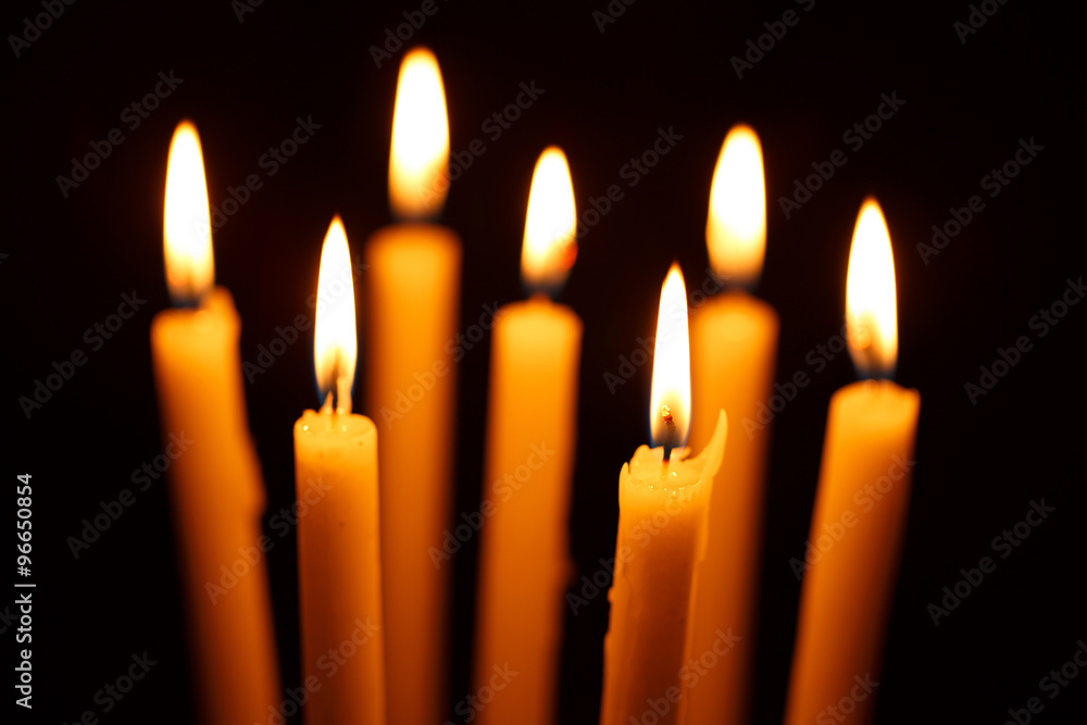 Many burning candles on black Many burning candles on black