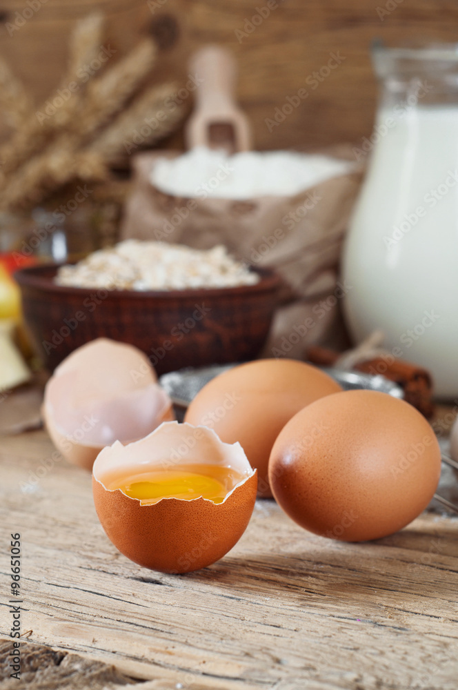 raw half eggs with ingredients for making bakery products raw half eggs with ingredients for making bakery products