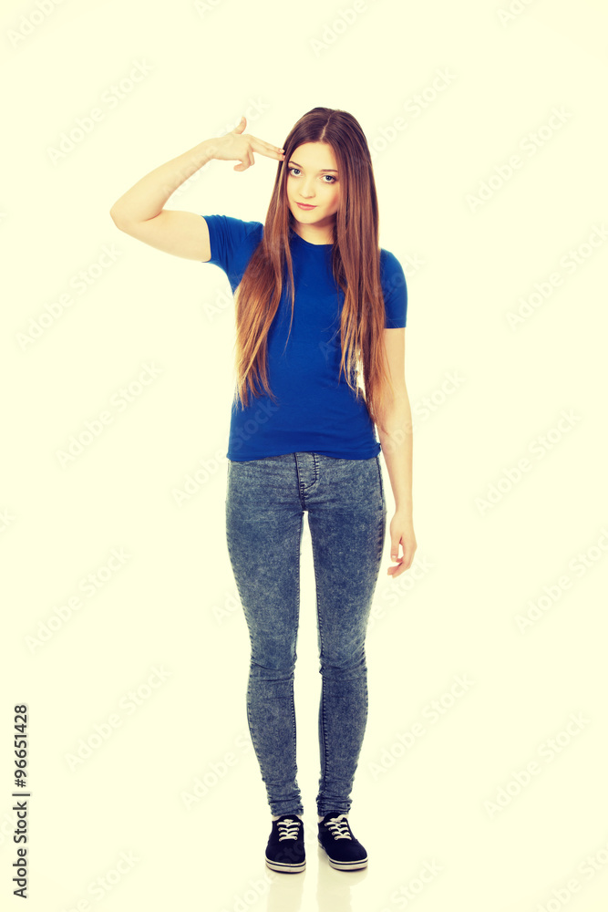 Despair teenage woman making gun sign. Despair teenage woman making gun sign.