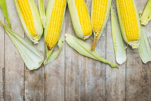 fresh corn on wooden table