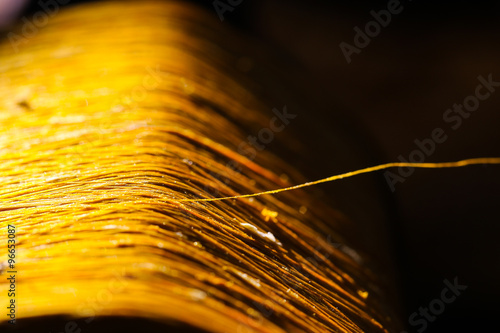 gold raw silk thread , black background