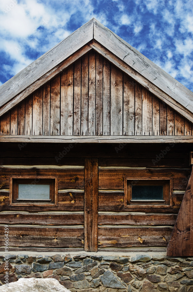 wooden barn with cloudy blue sky