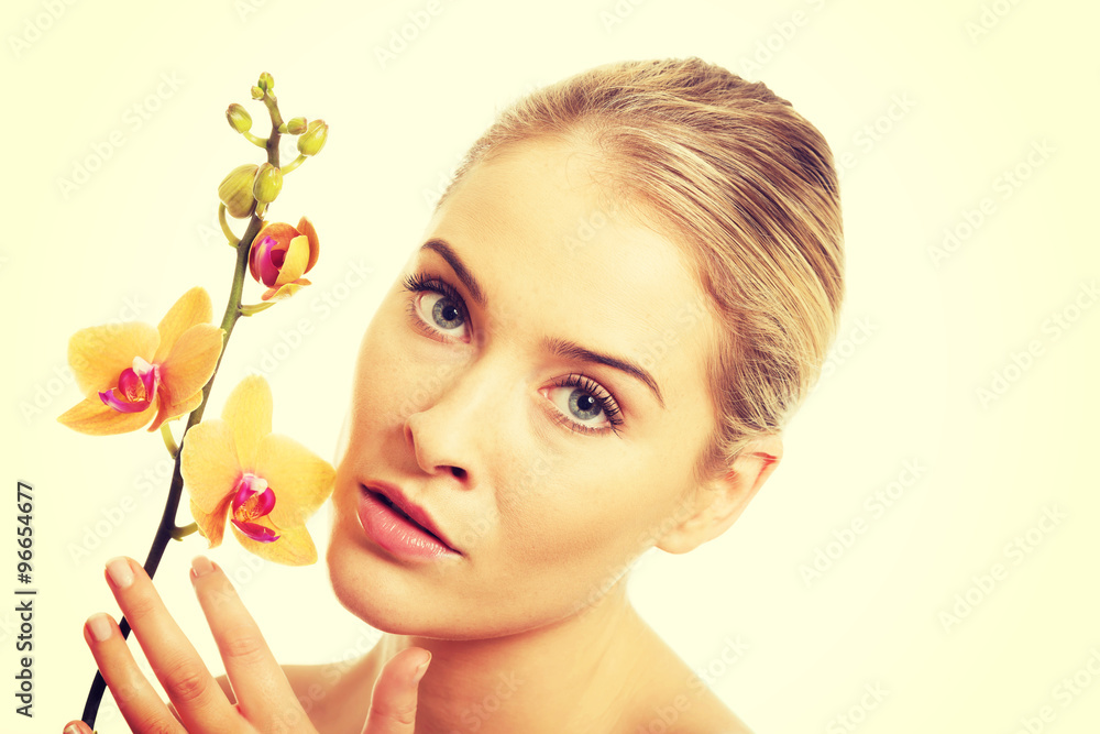 Fototapeta premium Beautiful spa woman with orange orchid