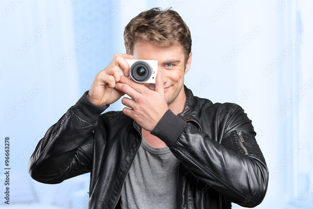 Young man doing a shot with a camera Young man doing a shot with a camera