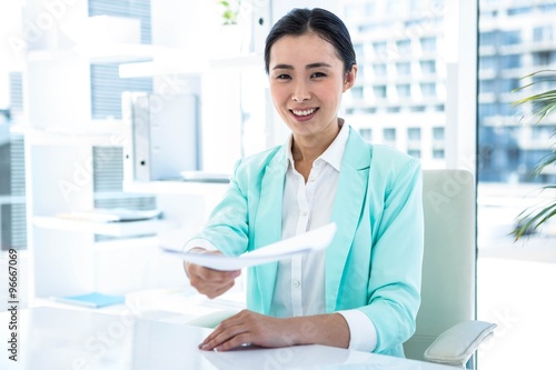 Smiling businesswoman taking notes