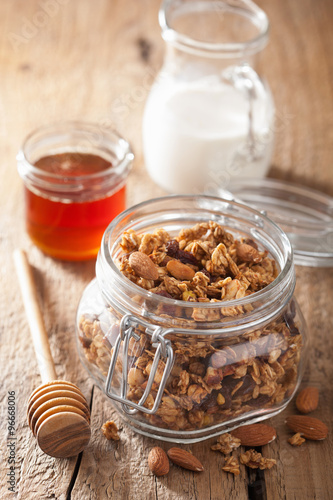 homemade healthy granola in glass jar and honey