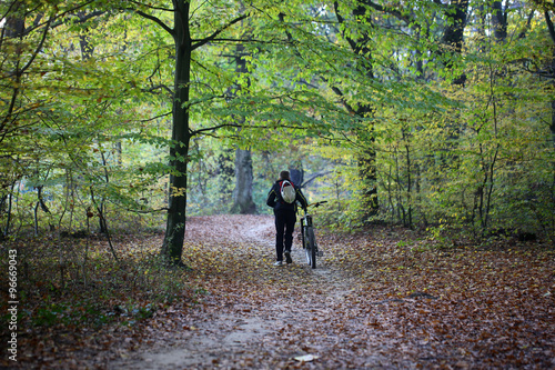 Male bicyclist in autumn park © Volodymyr