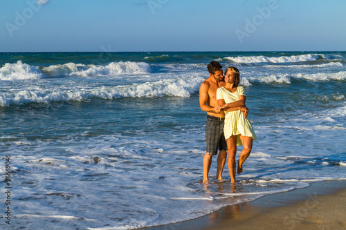 Attractive young couple in beachwear at the beach.