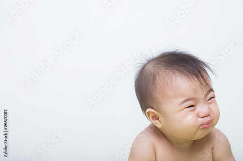 Portrait of a fever baby crying on background