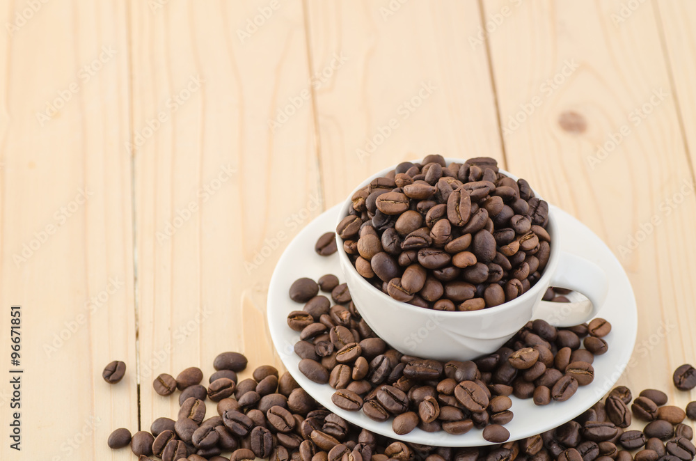 Fototapeta premium Cup of coffee full of coffee beans