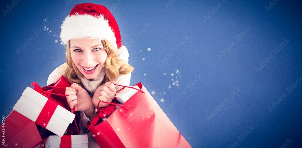Obraz premium Festive woman holding presents and shopping bags