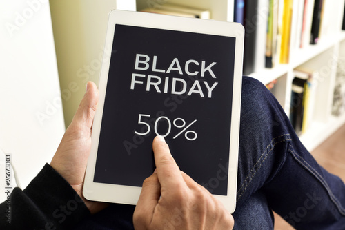 young man with a tablet with the text black friday