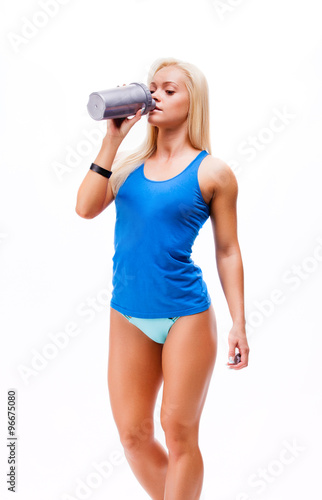 sporty muscular woman drinking water, isolated against white bac