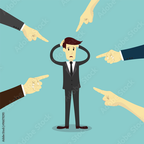 Hands pointing to blame businessman
