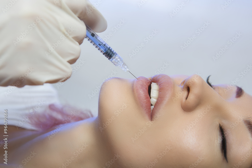 Woman Gets an Injection in her Lips in Beauty Salon Woman Gets an Injection in her Lips in Beauty Salon
