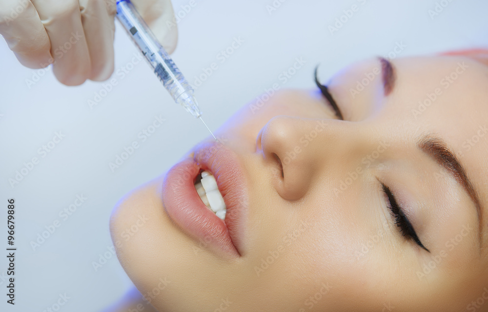 Woman Geting an Injection in her Lips in Beauty Salon Woman Geting an Injection in her Lips in Beauty Salon
